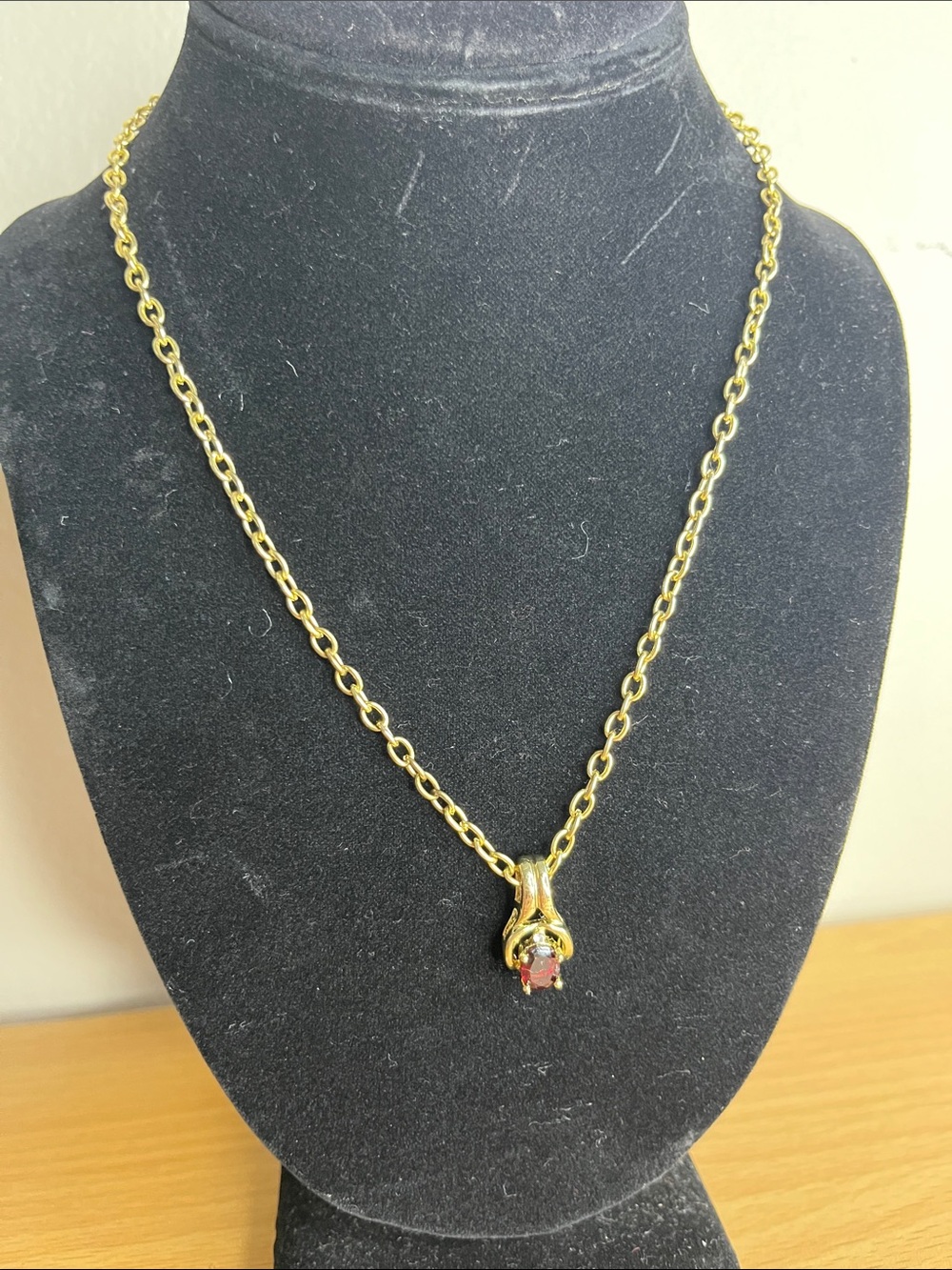 Gold color necklace with red stone